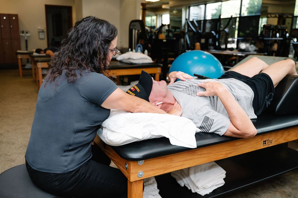 Jaffe Sports Medicine patient performing a physical therapy exercise for pain relief and rehabilitation under expert supervision.